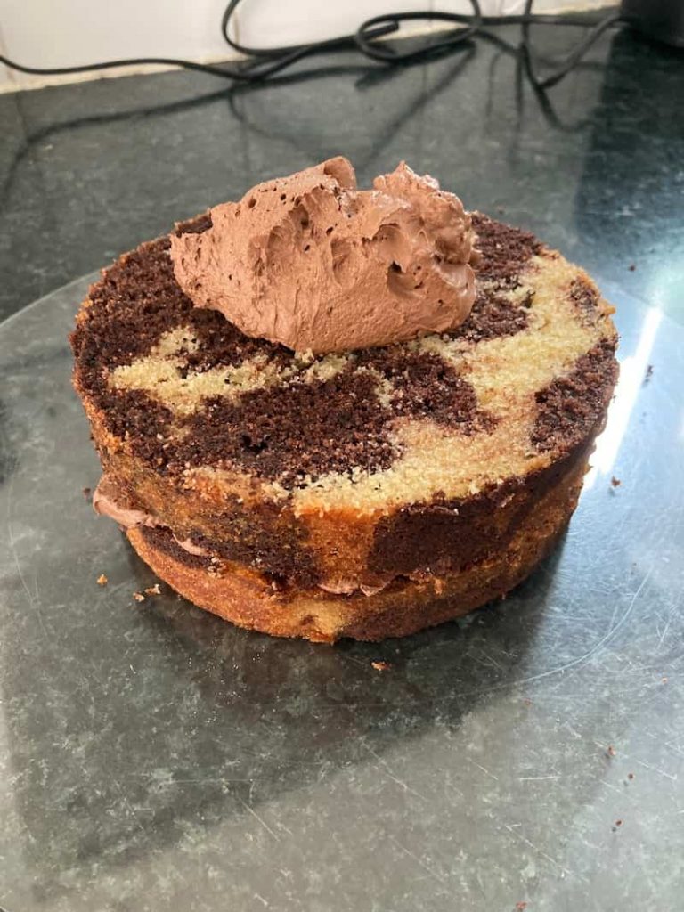 second layer of a semi-naked cake with frosting
