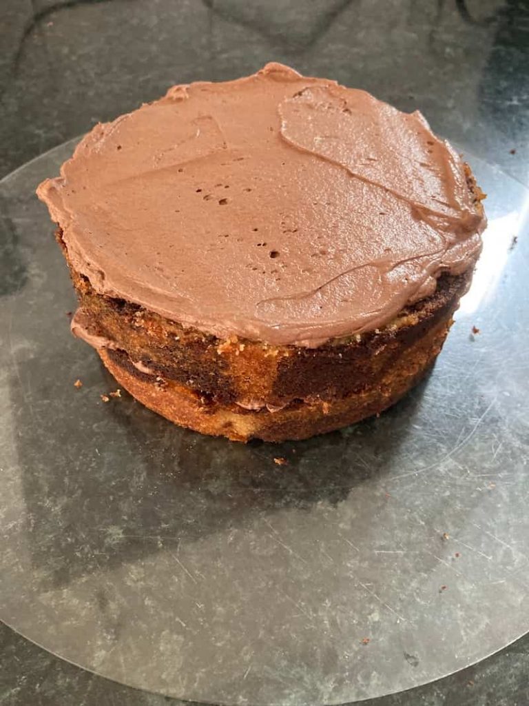 second layer of a semi-naked cake with frosting