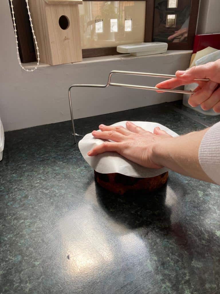 cutting a cake with a cake saw
