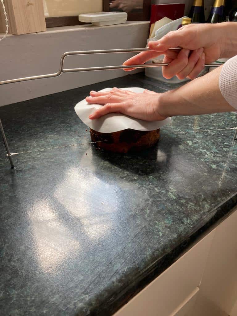 cutting a cake with a cake saw